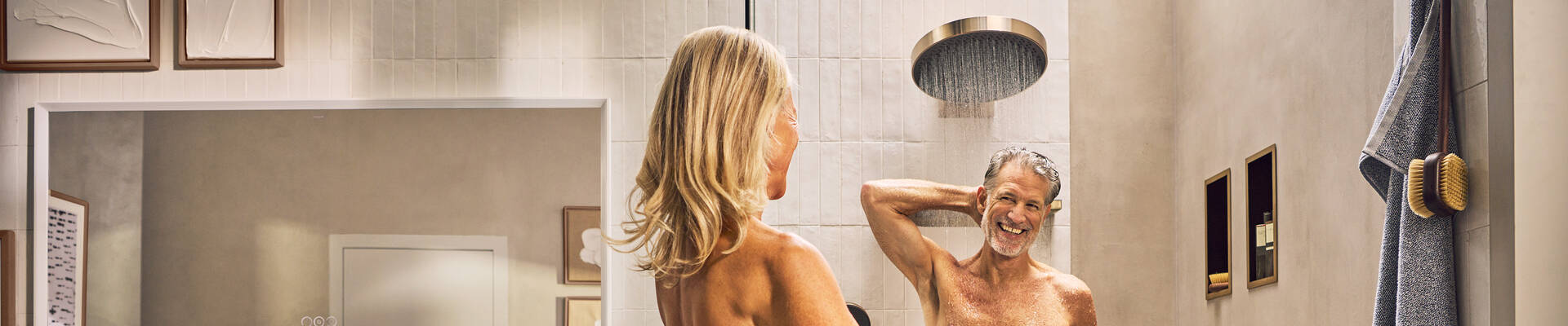 Happy woman taking a shower