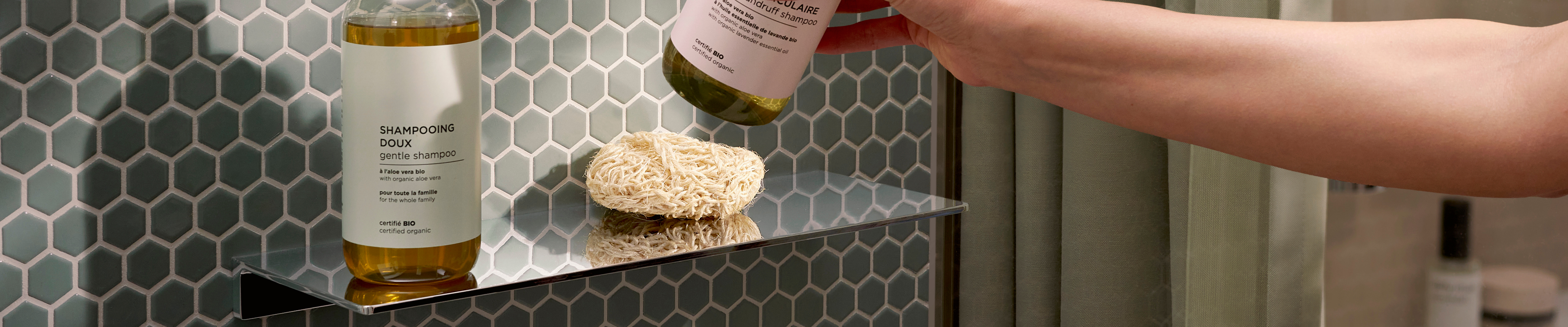 Man using the hansgrohe AddStoris S soap dispenser.