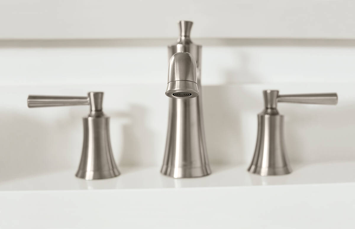 Tap in matt brushed bronze with a white wash basin.