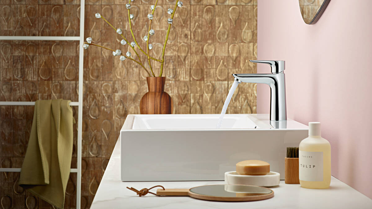 Shining chrome tap on a white wash basin.