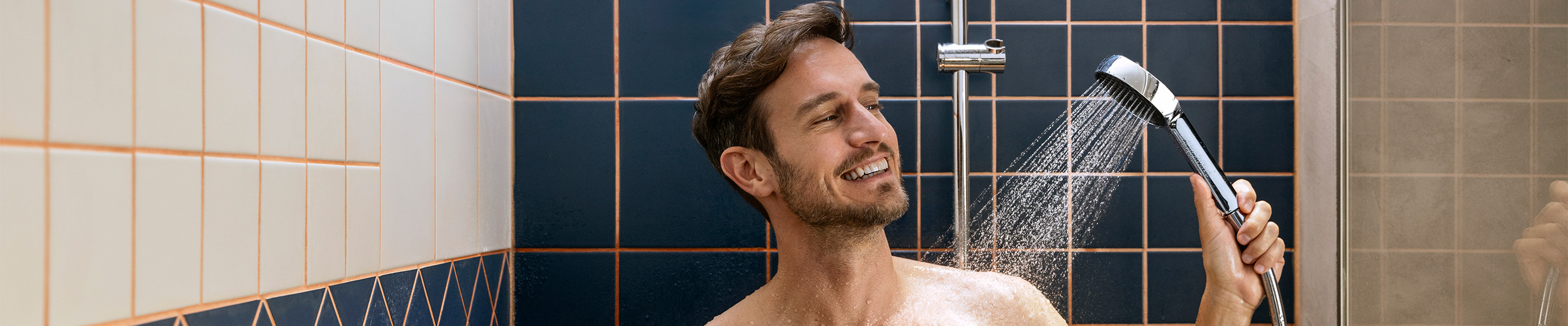Man showers happily with Activera hand shower.