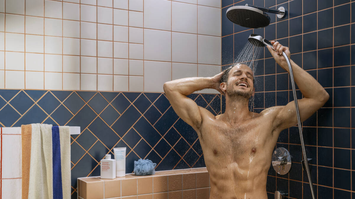Man standing under a shower.