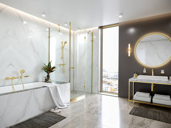 Colour-coordinated bathroom accessories in Polished Gold Optic.