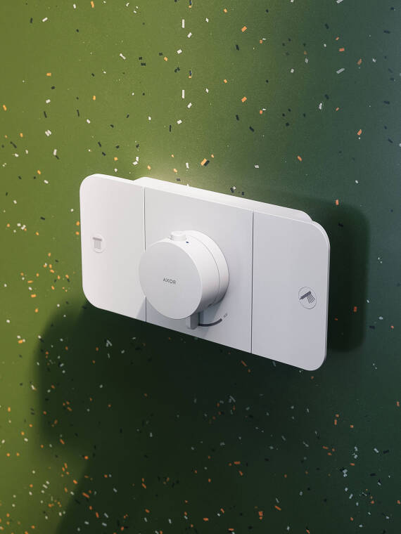 AXOR One Thermostatic module in Matt White in front of the green tiles AXOR One Thermostatic module in Matt White in front of the green tiles