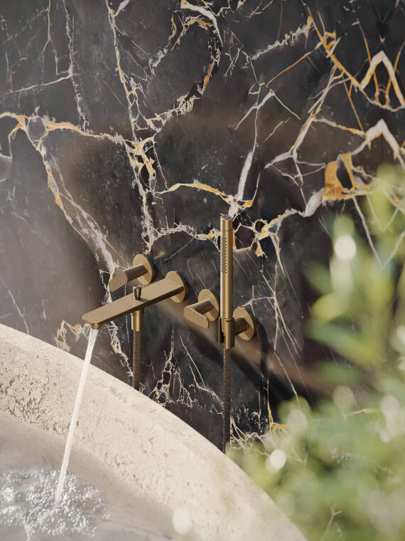 Close-up of the AXOR Citterio C 3-hole bath mixer for wall mounting with shower holder. Close-up of the AXOR Citterio C 3-hole bath mixer for wall mounting with shower holder.