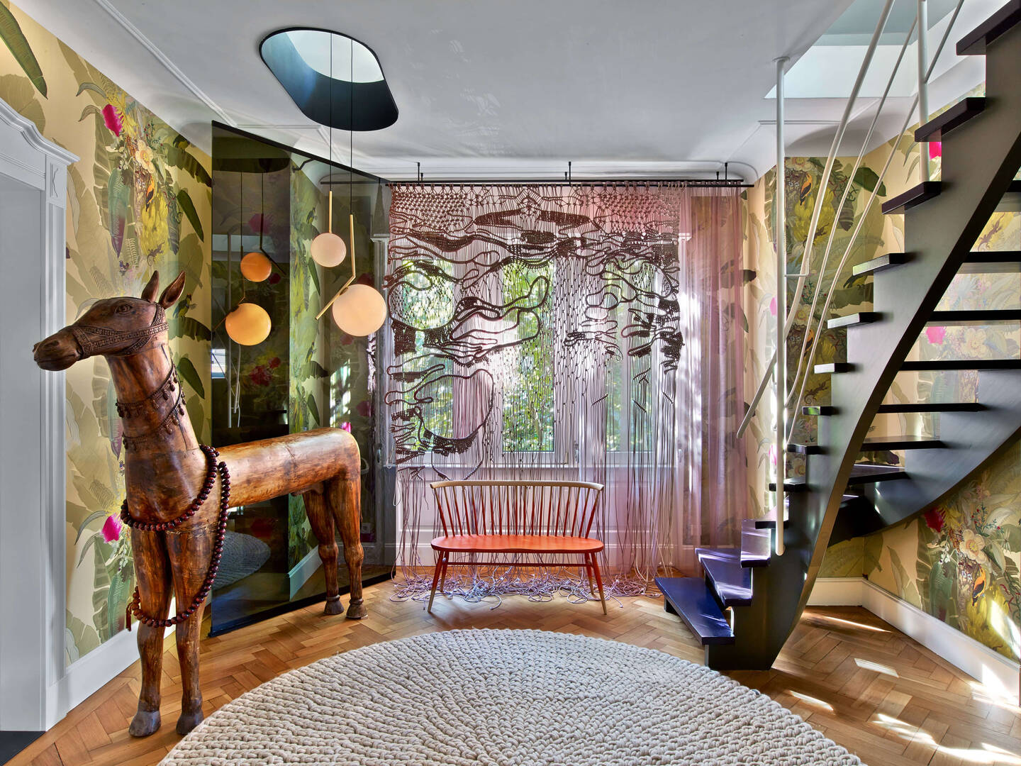 A hallway in Maisonette P155 with a wooden horse sculpture.