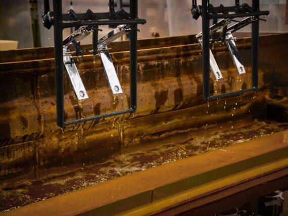 Fixtures are submerged in a series of chemical baths during the electroplating process. Fixtures are submerged in a series of chemical baths during the electroplating process.