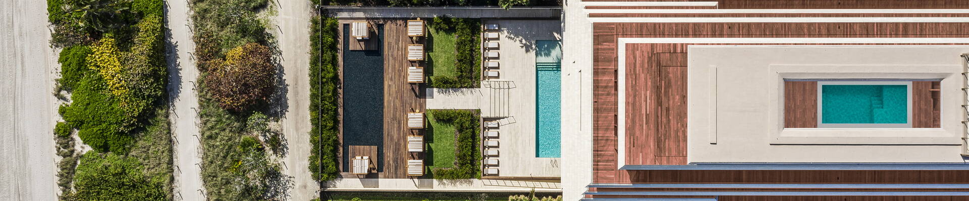 Aerial view of Arte Surfside Miami showing garden and pools. Aerial view of Arte Surfside Miami showing garden and pools.