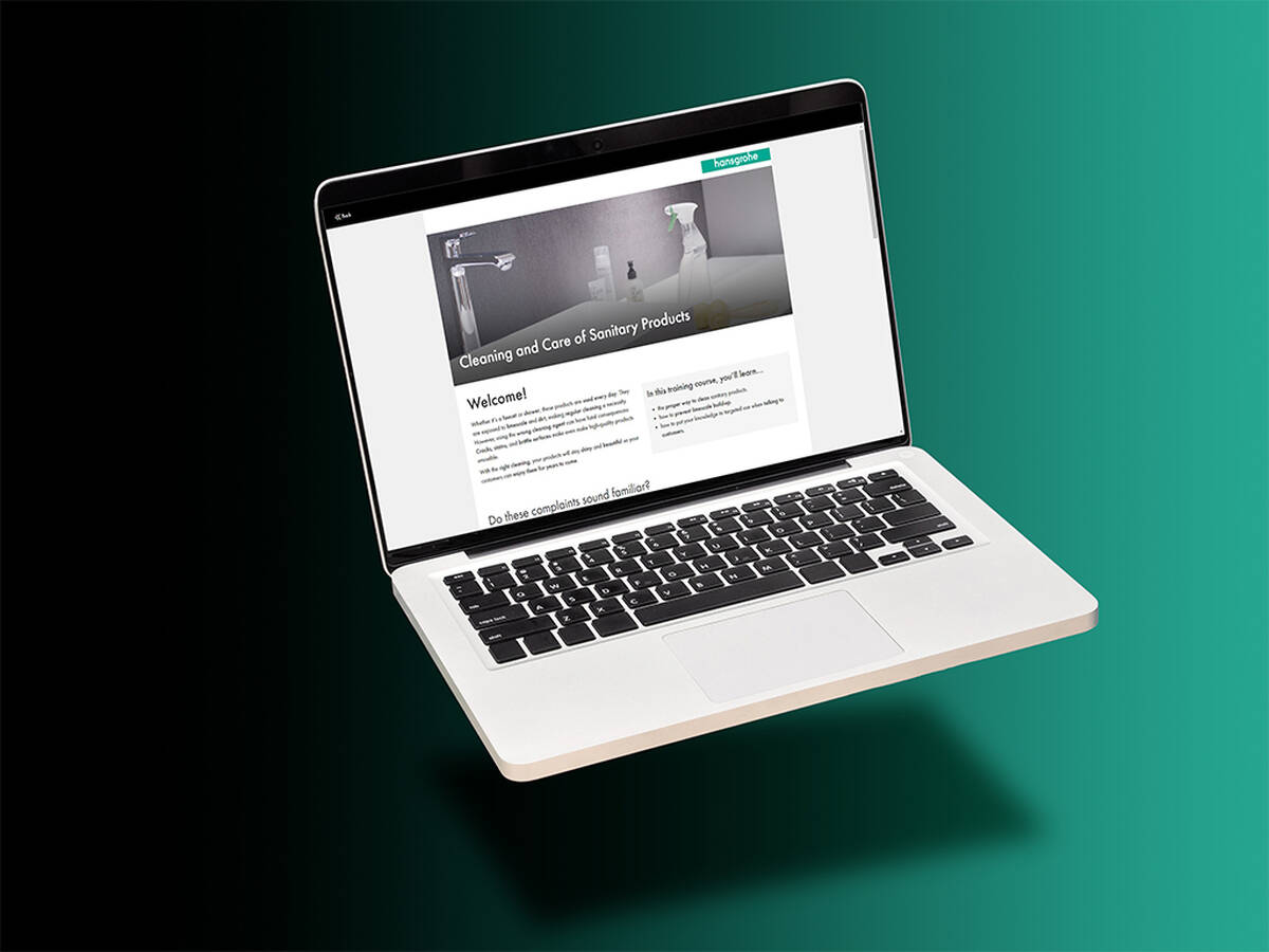 Person using Hansgrohe Online Aquademie on a notebook.