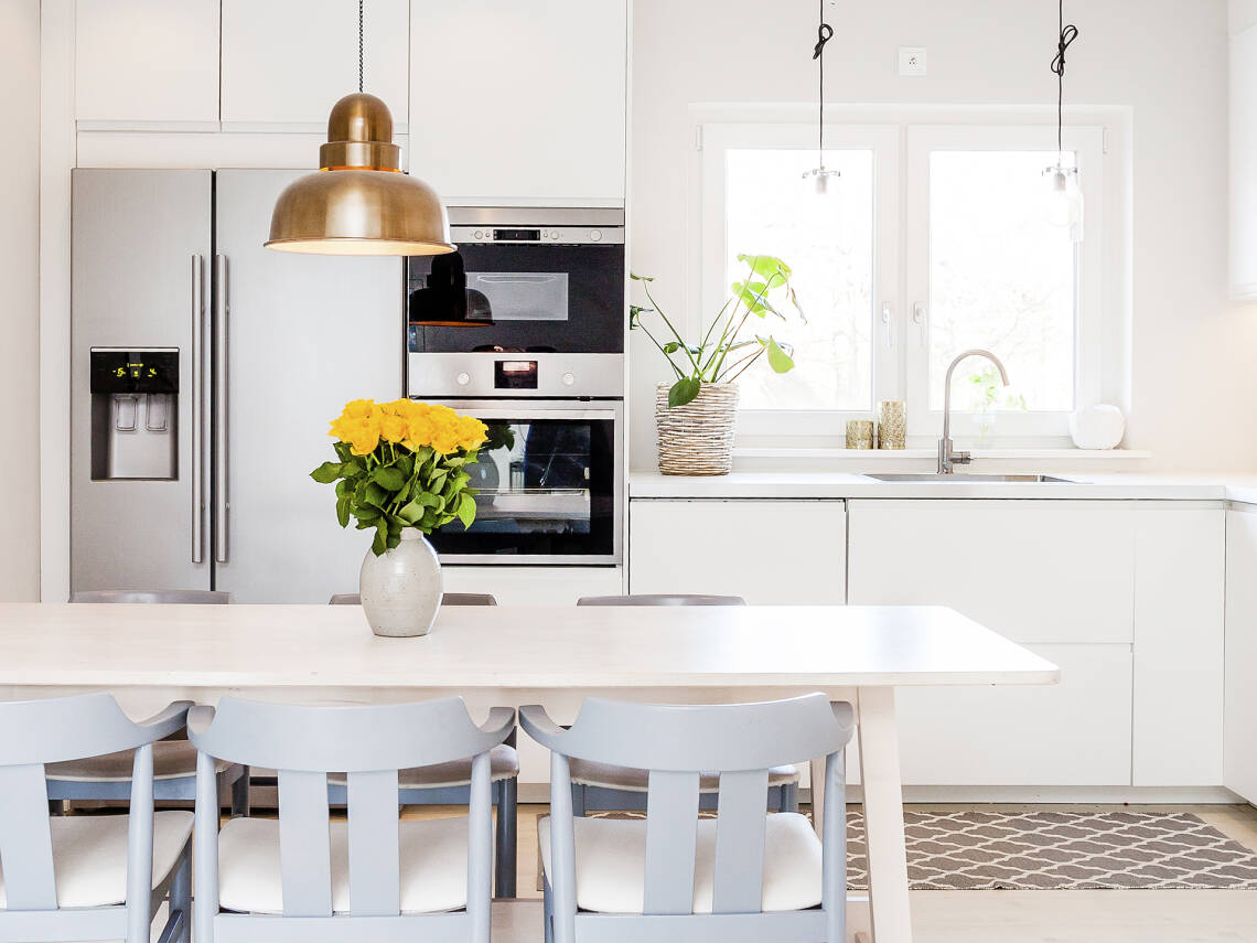 Modern cabinets, industrial light fixture, plants and flowers