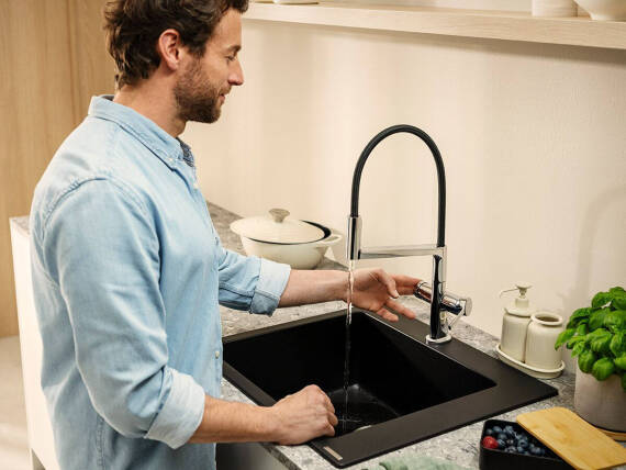 Man using the Talis Select M54 PowderSpray kitchen faucet.