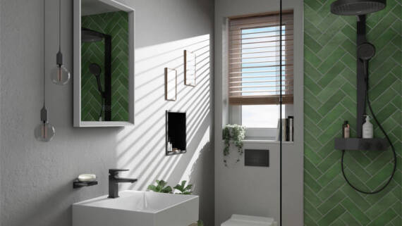 Modern small bathroom with green tiles.