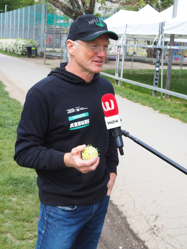 Andreas Fath illustrates pollutants with a tennis ball.