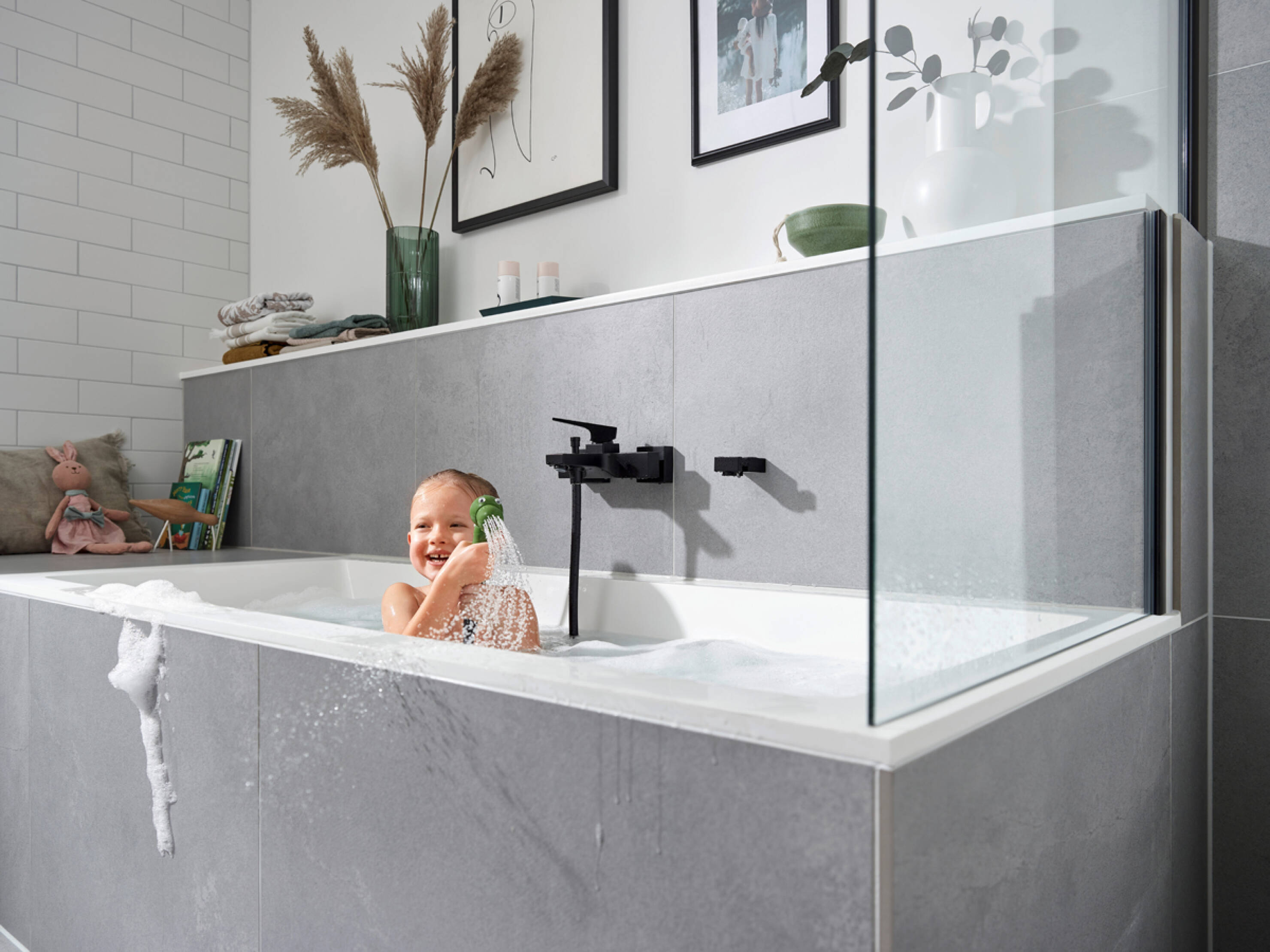 Girl playing with hansgrohe Jocolino children’s shower. Girl playing with hansgrohe Jocolino children’s shower.