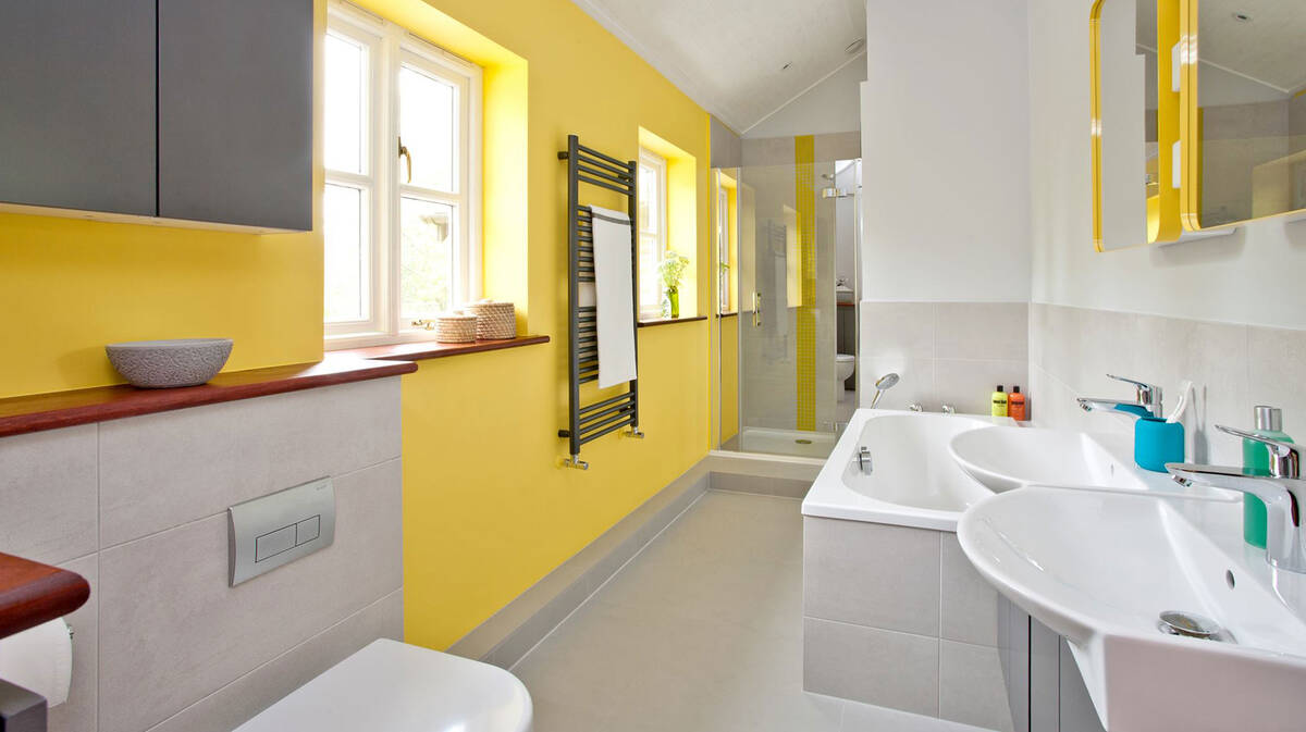 Cheerful bathroom design in light pastel shades and sun yellow.