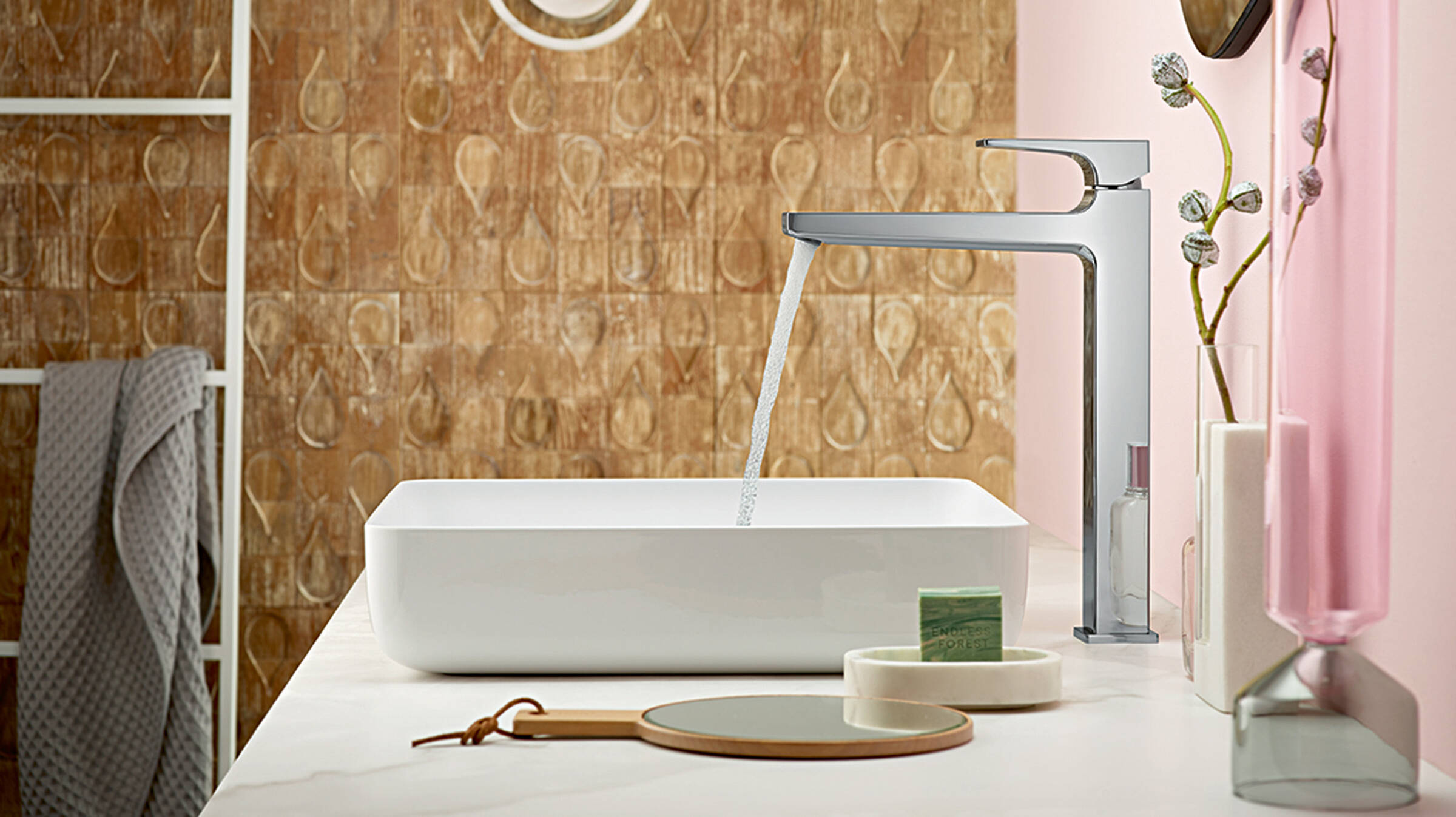 Shining chrome tap on a white wash basin.