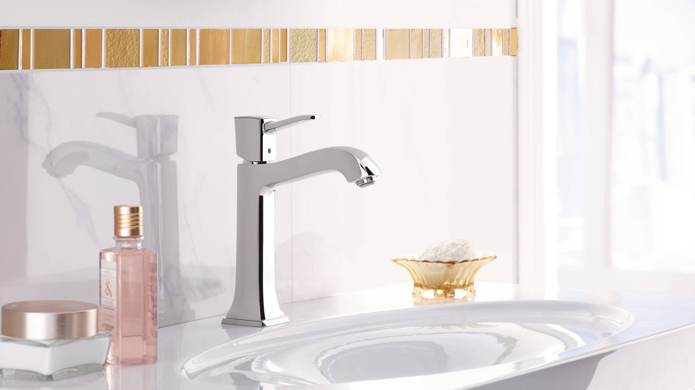 Faucets with gold accents in a classical bathroom.