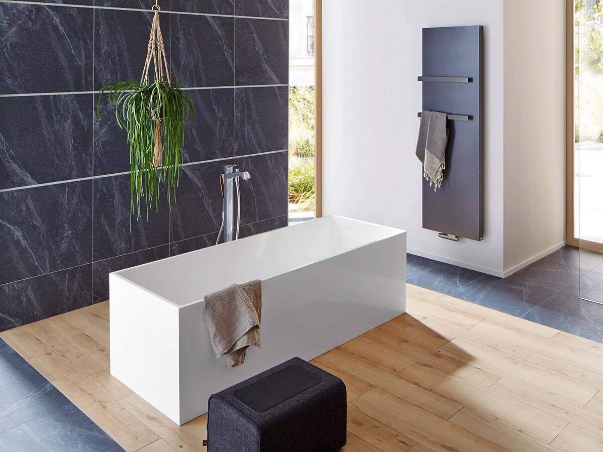 Freestanding bath tub and shower area with high-contrast design.