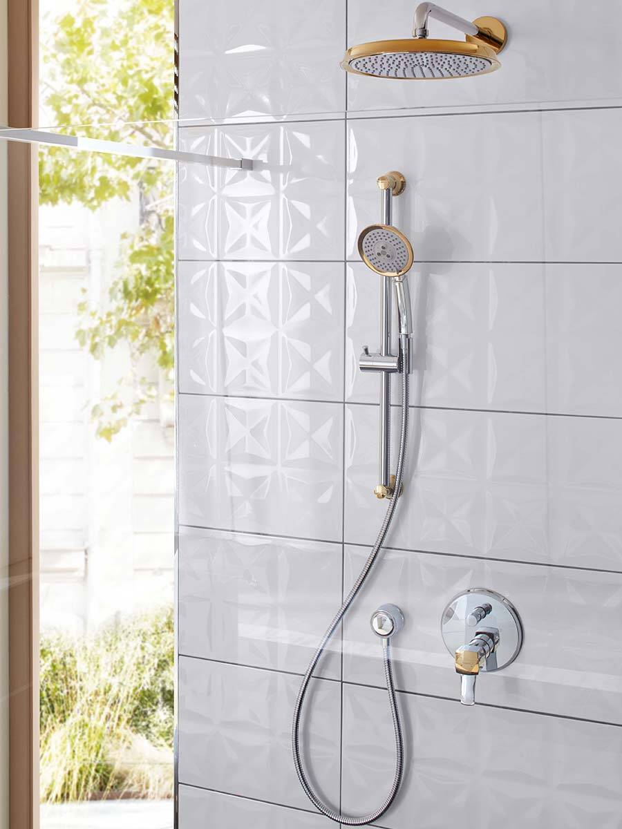 Shower with overhead and hand shower in elegant chrome and gold.