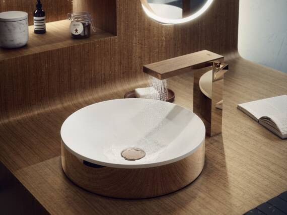 Basin mixer with an individual designed plate