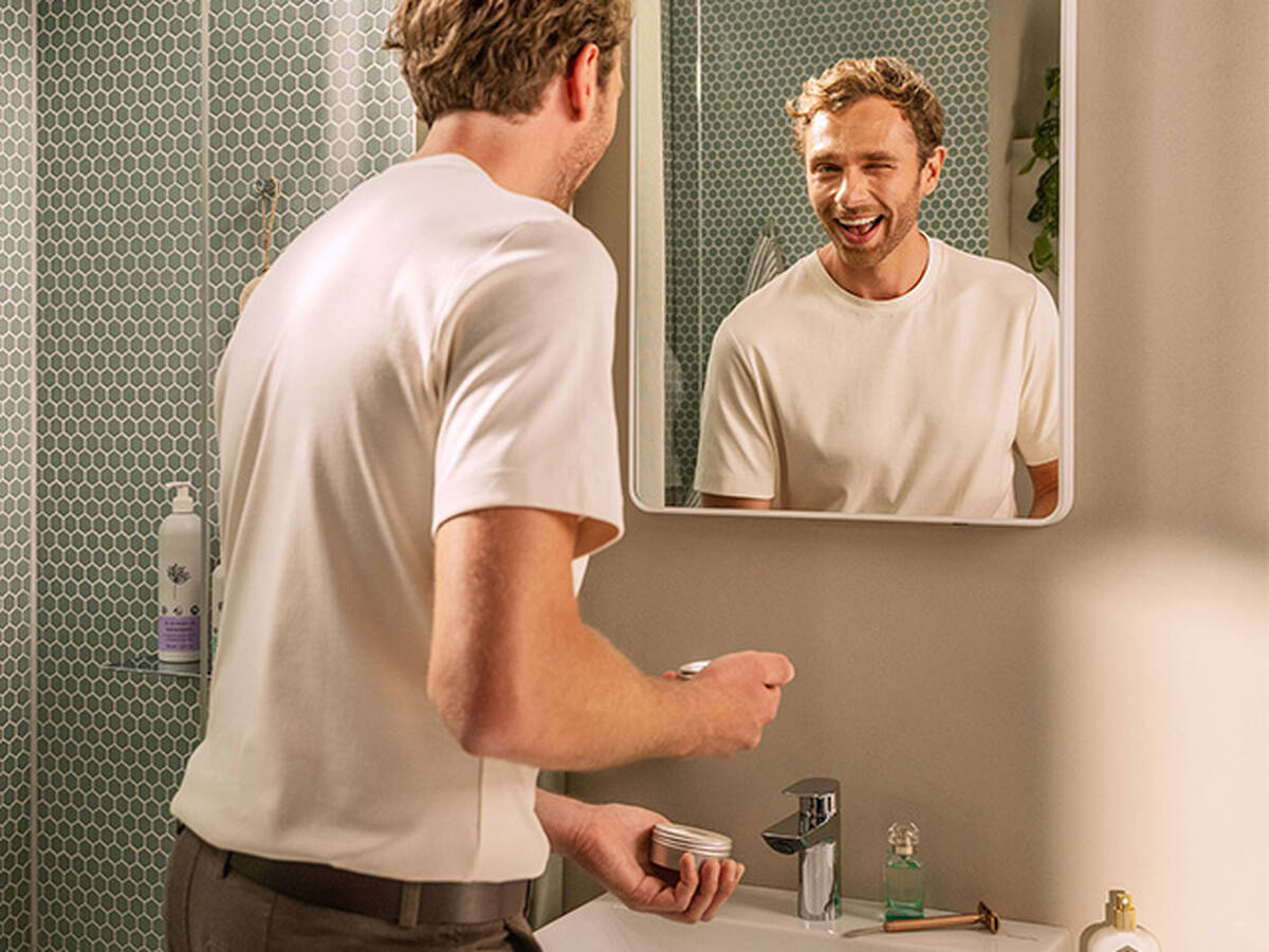 Man checks his appearance in the Xarita Lite mirror.