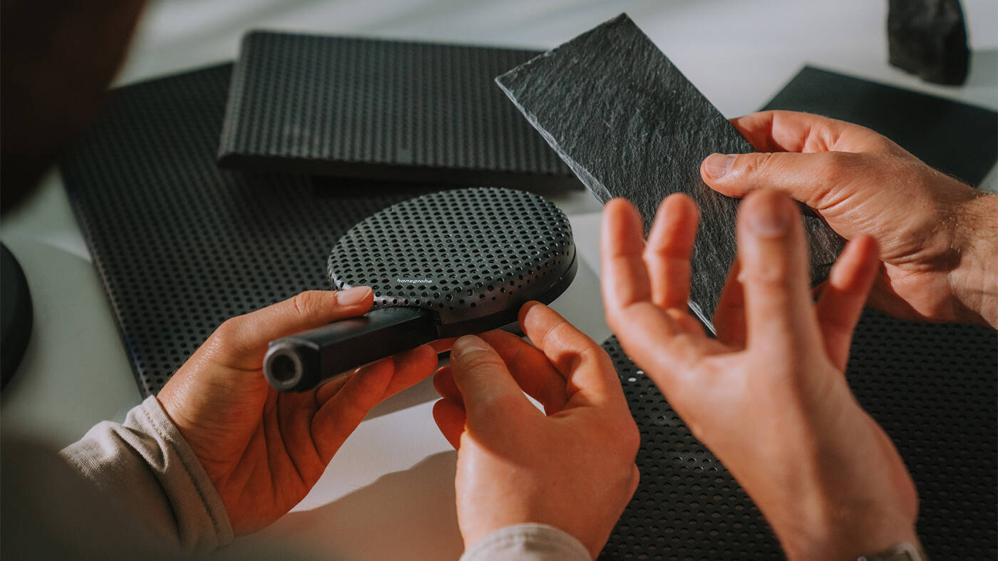 Designer with a round hansgrohe rain shower close up.