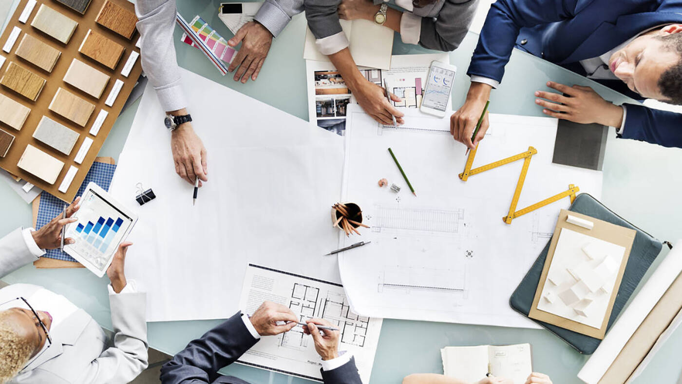 Professional planners at a desk with their drawings. 