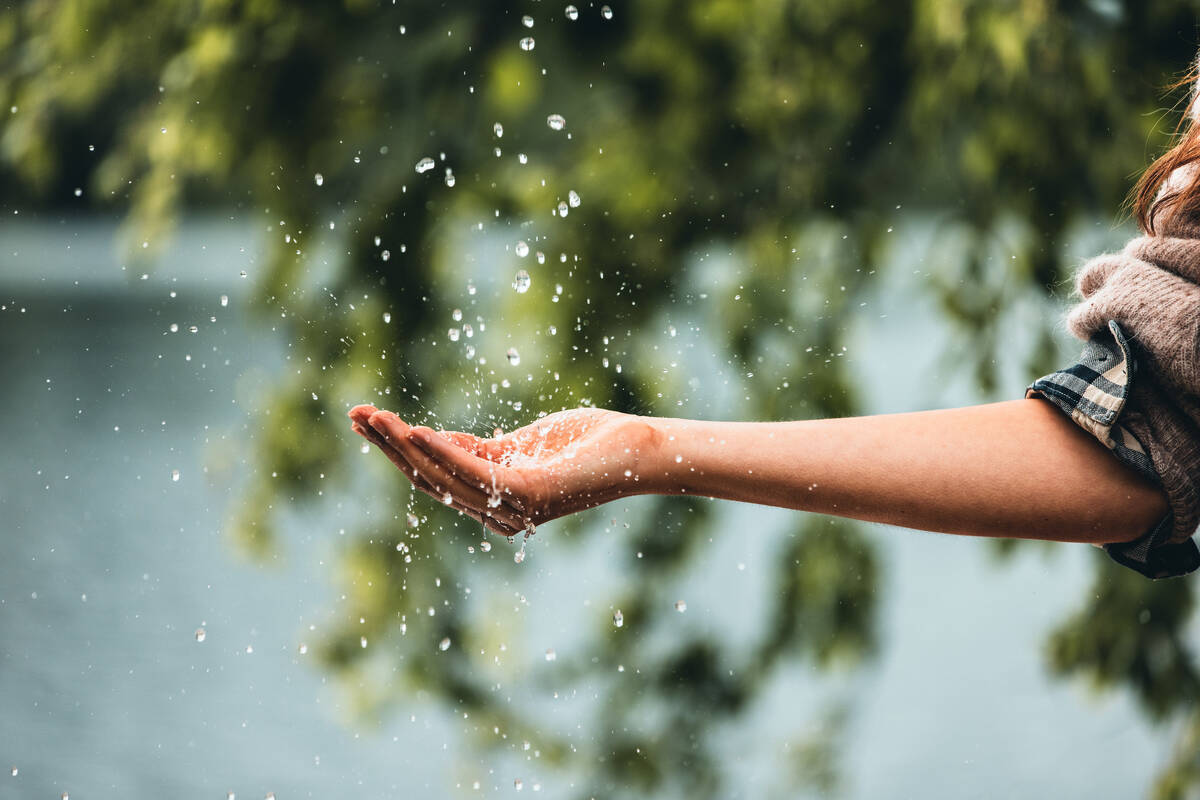 Woman showering with hansgrohe Planet Edition shower.