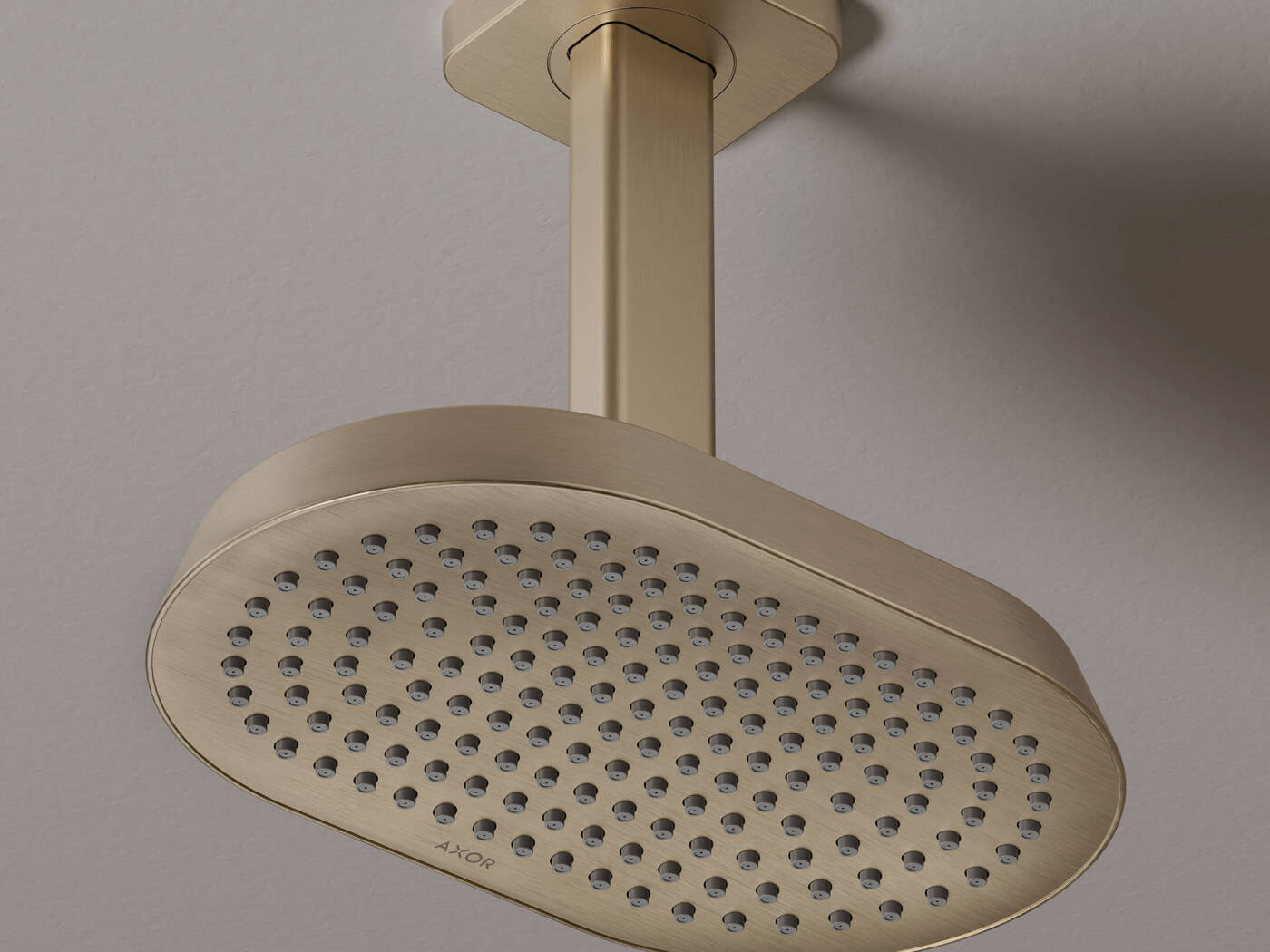 Close-up of an AXOR ShowerSphere overhead shower with ceiling connector in Brushed Brass.