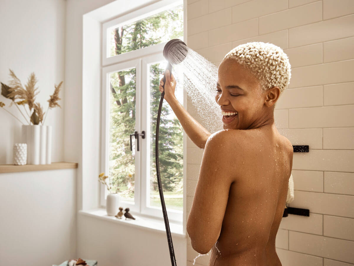 Woman with Pulsify S Select hand shower.