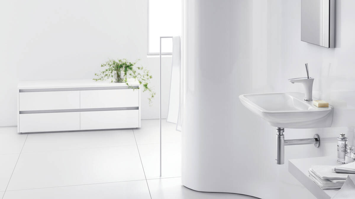 Blanc et chrome combinés noblement dans une salle de bains avant-gardiste. Blanc et chrome combinés noblement dans une salle de bains avant-gardiste.