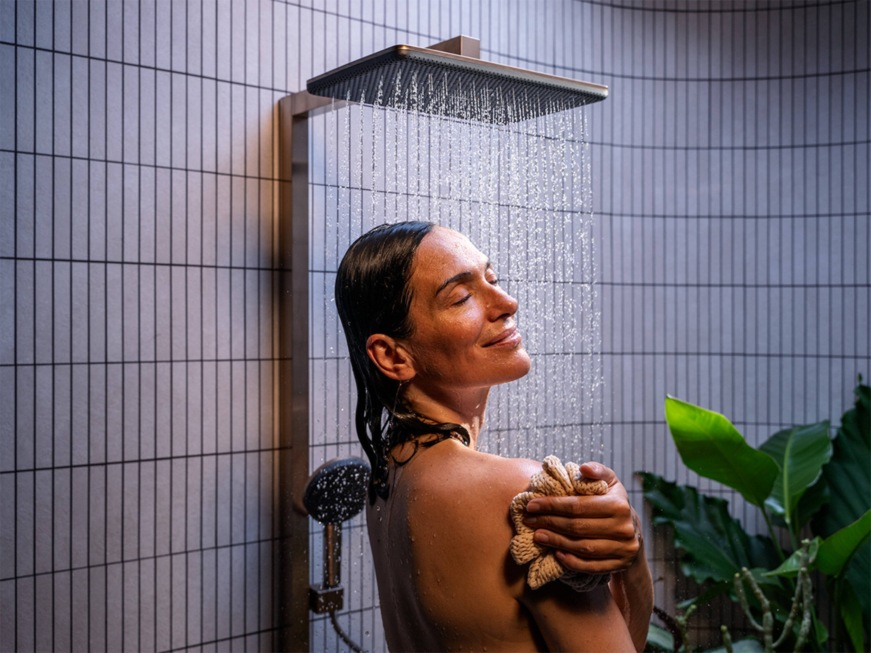 Woman enjoying shower with AirPower technology.
