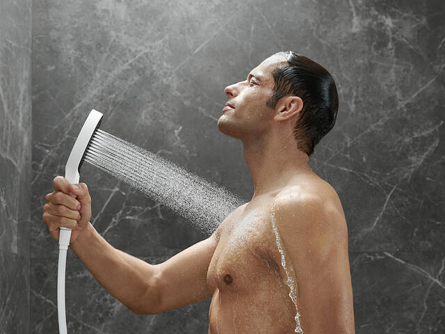 Woman showering with Rainfinity hand shower.