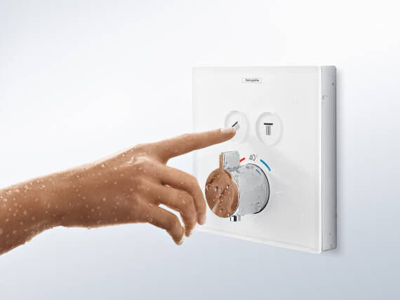 Child’s hand touching a thermally decoupled thermostat.