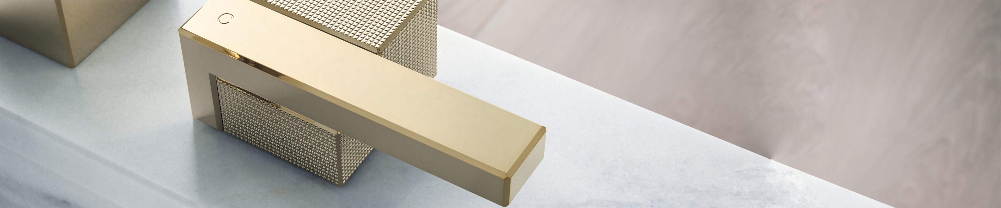 AXOR Edge bath mixer. Prismatic handle. Polished Gold Optic.