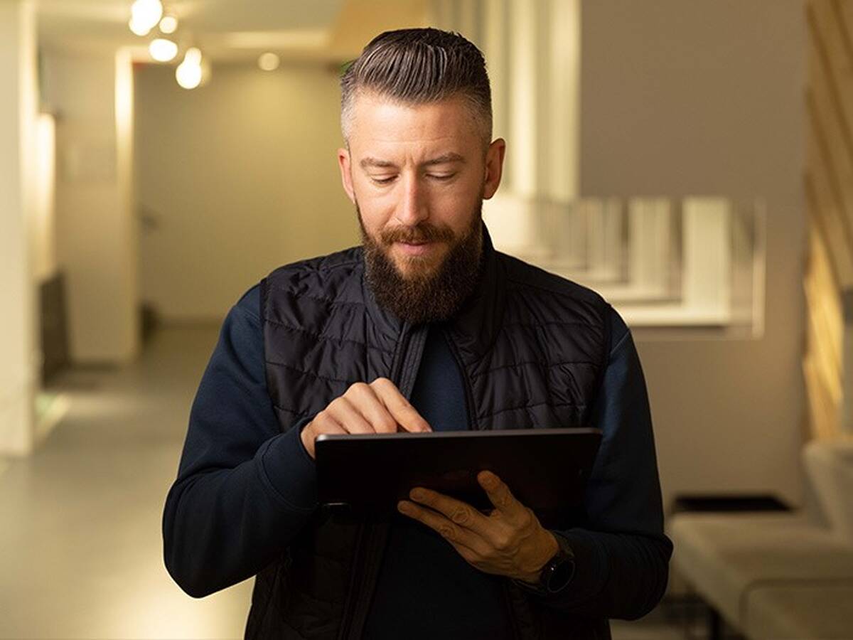 Man tapping on a tablet.