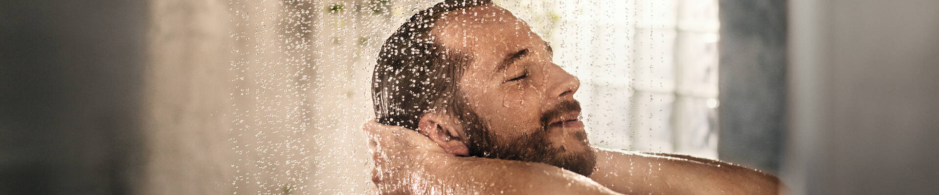 Man tests hansgrohe shower. Man tests hansgrohe shower.