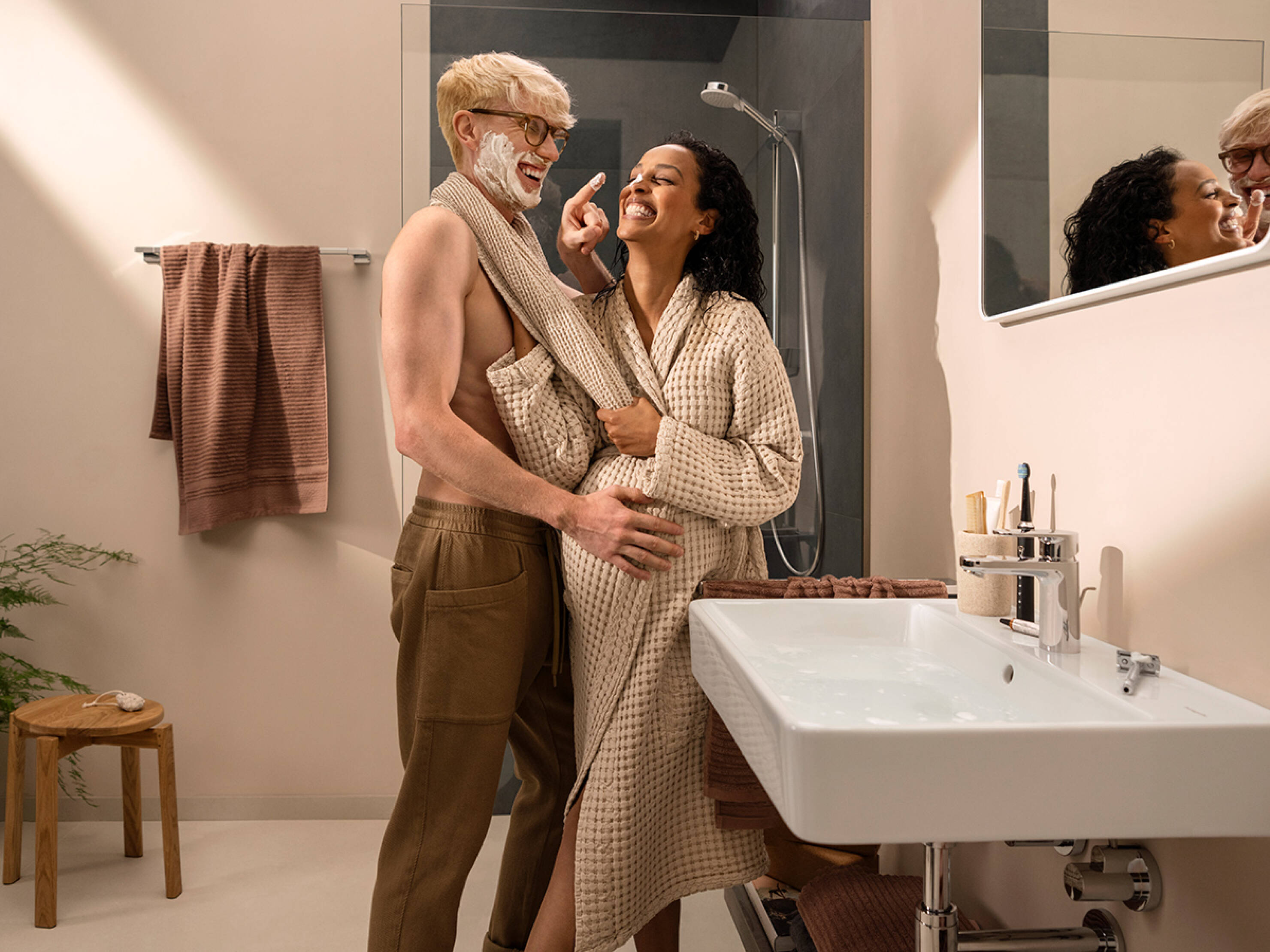 A couple mess about by a Xanuia Q wash basin.