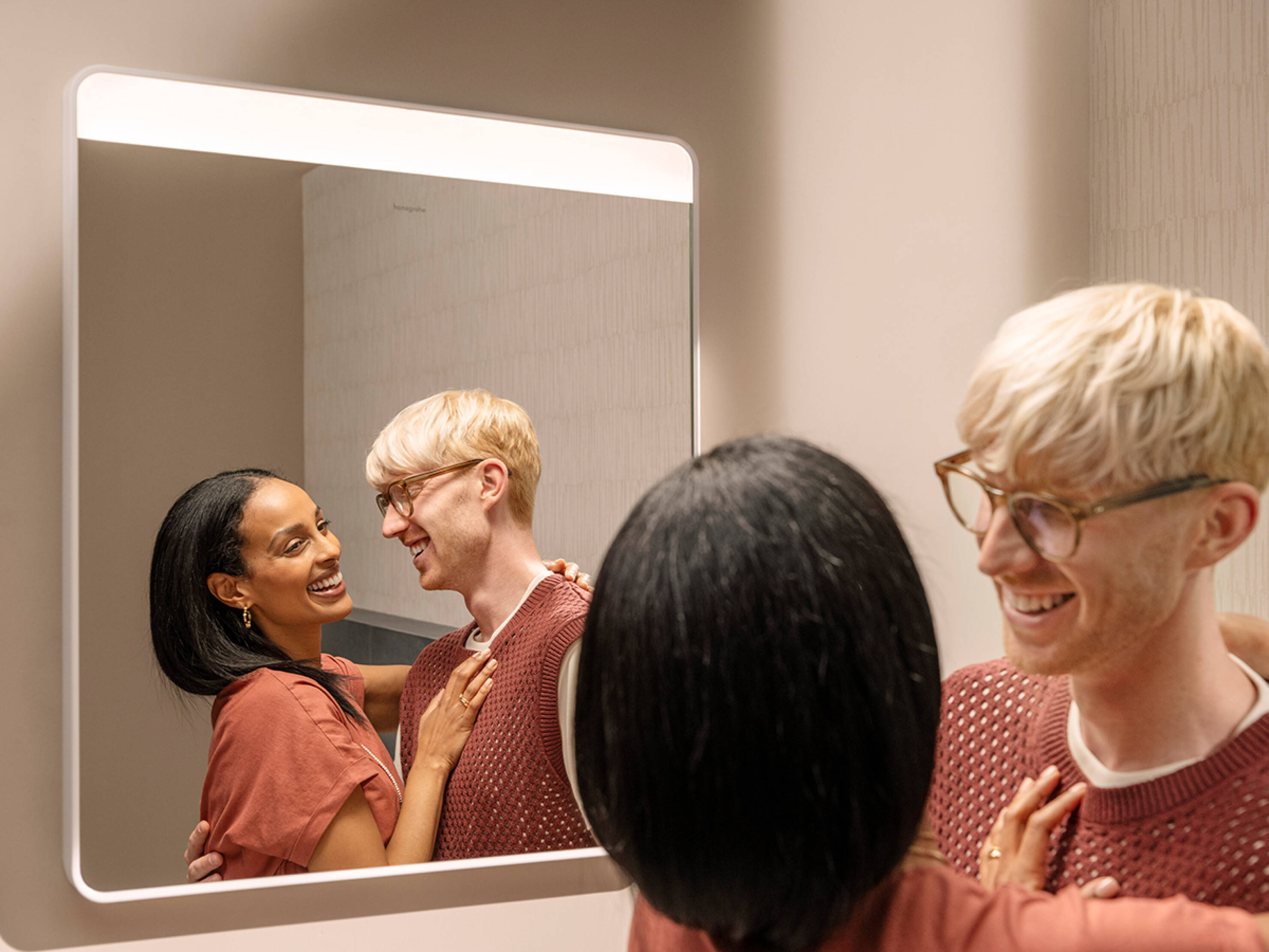 A happy couple by an illuminated Xarita Lite Q mirror.