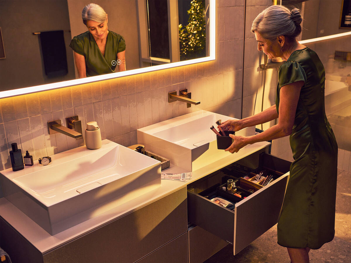 Elegant woman at a premium-quality hansgrohe wash basin.