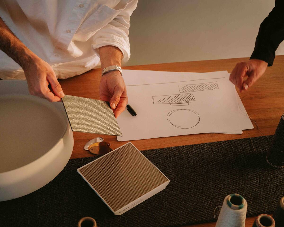 Woman showering with hansgrohe Planet Edition hand shower.