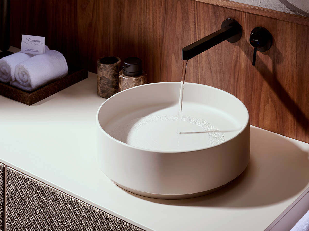 Round Xuniva Evo counter top wash basin on a console.