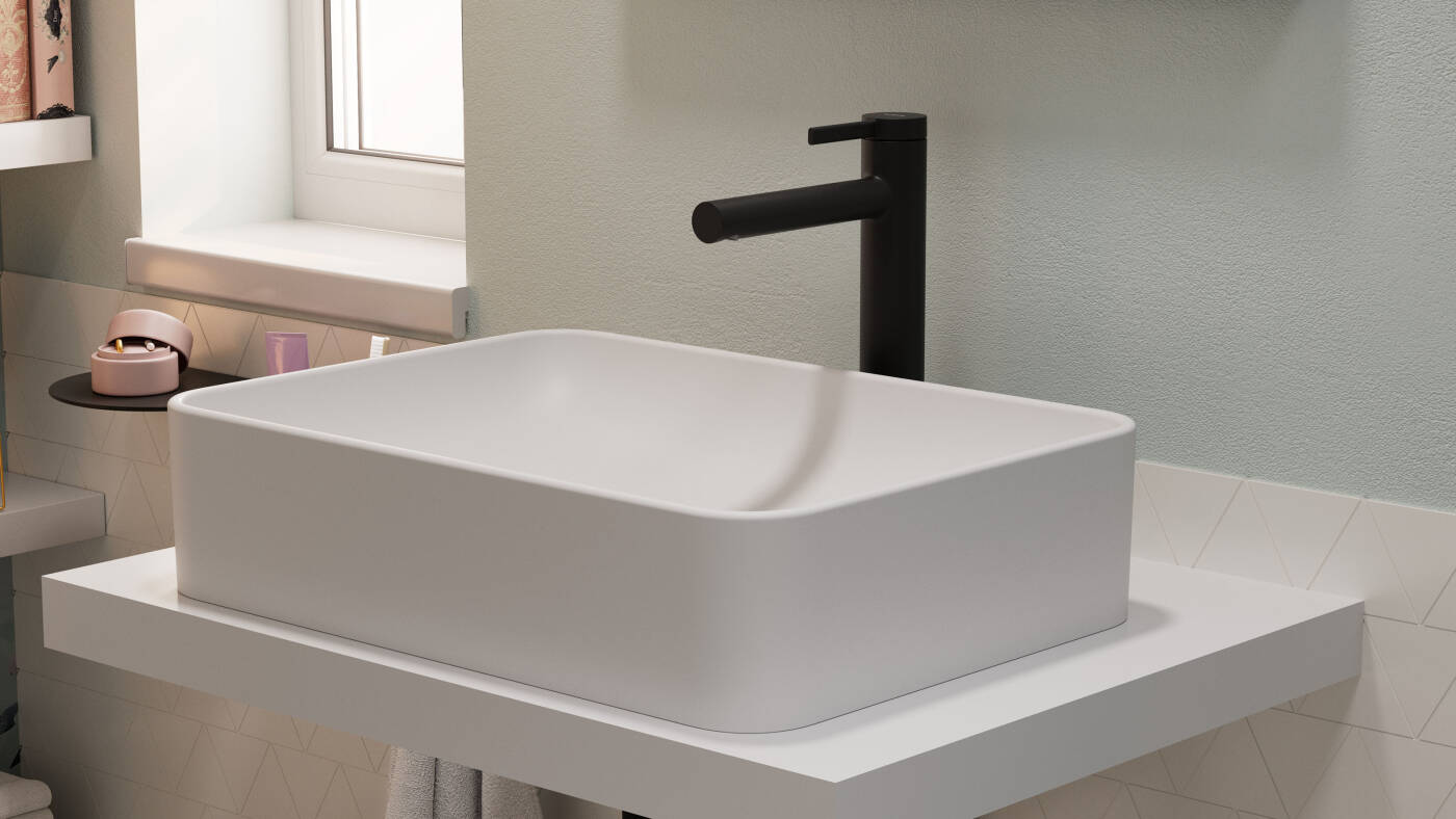 Matt Black Zesis S lavatory faucet behind the wash bowl.